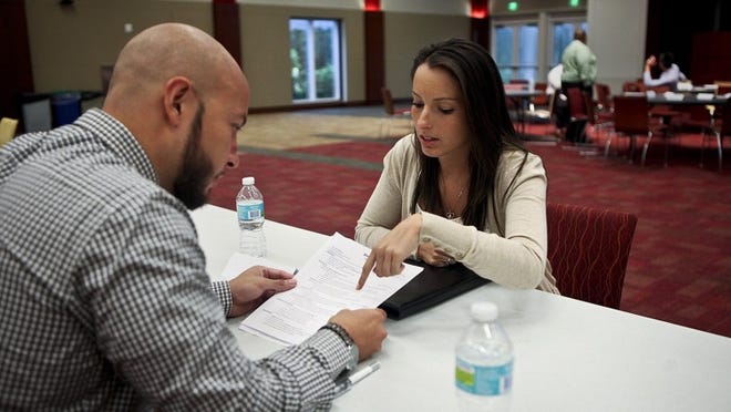 From left, Carlos Morgan, a senior recruiter, talks with Melysa Gross about her resume Wednesday at the Office Depot headquarters in Boca Raton. Gross, a finance major at Florida Atlantic University, was among about 40 of the company’s interns who attended the educational seminar. It featured a presentation about finding employment and a 1-on-1 resume critique.