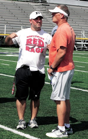 Seth (left) and his dad, Vic Whiting work with the West team at Jackson High School's Robert Fife Stadium.