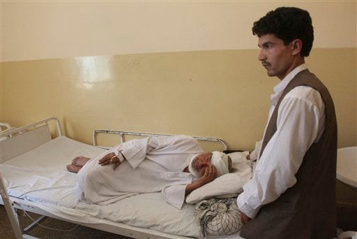 An Afghan man who was wounded in a suicide attack lies in a hospital in Samangan province north of Kabul Afghanistan, Saturday, July, 14, 2012. A suicide bomber blew himself up Saturday in a wedding hall in northern Afghanistan, killing at least 23 people including a prominent warlord-turned-politician and three Afghan security force officials, in an attack that deals a setback to efforts to unify the nation's ethnic factions, Afghan officials said. (AP Photo/Jawed Dehsabzi)