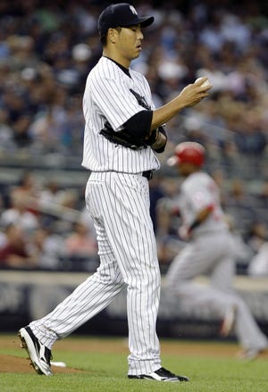 Yankees starting pitcher Hiroki Kuroda reacts after allowing a home run to the Angels’ Erick Aybar on Friday after hitting a home run during the third inning of New York’s 6-5 win at Yankee Stadium.