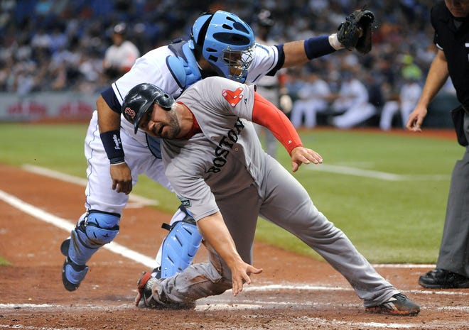 Tampa Bay Rays catcher Jose Molina, rear, catches Boston Red Sox's Kelly Shoppach at home for the out with the bases loaded to end the top of the fifth inning of a baseball game Saturday, July 14, 2012, in St. Petersburg, Fla. (AP Photo/Brian Blanco)