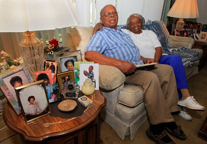 Jewell Wilson, great-grandson of former slave Jordan Anderson, is flanked by photos of family members as he sits with his wife, Estella Wilson, at their home in Dayton, Ohio. Anderson, who wrote a remarkable letter to his ex-master, was freed from a Tennessee plantation by Union troops in 1864 and spent his remaining 40 years in Ohio.