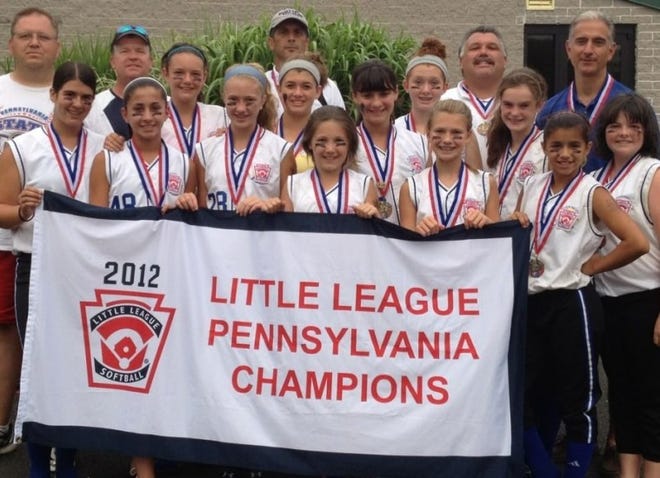 The Warrington Warwick Little League Major League softball team won the Pennsylvania state championship. Team members include (front row, from left) Sabrina Dobron, Giuliana Ruscio, Alexis McConomy, Madison Bitting, Cassie Underkofler, Alexandra DeLeon and Kaitlyn Hammond. In the second row are Meghan Bradley, Lauren Corso, Stephanie Andreoli, Nicole Corso and Madeleine McShane. In the third row are Mike Bradley, Dennis McConomy, head coach Steve Bitting and coaches Mike Corso and Pat Ruscio. Sophia Boggs is missing from the photo.
