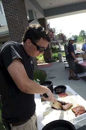 Corey Powers of the Kittery Fire Department prepares ribs at the first Kittery Barbecue Throw Down in Kittery on Saturday. The Fire Department won the competition at Kittery Estates, over the Kittery Police Benevolent Association and Kittery Estates teams. The event benefitted the Footprints Food Pantry.




Julian Russell/ Staff photographer