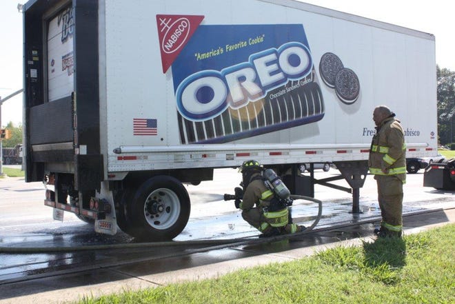 Oak Ridge firefighters extinguish a fire under an Oreo truck.