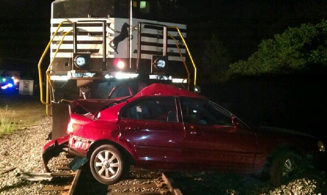 A Norfolk Southern train slammed into this car stranded on railroad tracks in Louisville early Saturday.