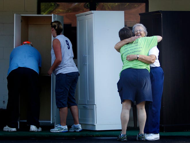 Independent Living for Retarded Adults President and founder Aline Klein gets a big hug from resident Tammy Venable outside some of the apartments at 8660 SW 27th Ave., on Saturday, July 14, in Ocala, Fla.