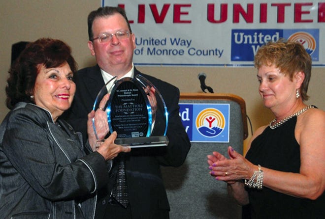 Dr. Rose Mattioli, left, receives the United Way of Monroe County Philanthropic Award from United Way Board President Curtis Rogers and Executive Director Mathilda Sheptak.