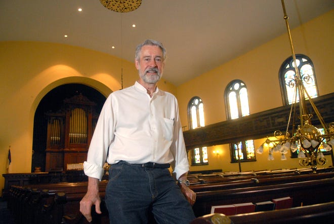 The Rev. John Lancz shows off the finished renovation work at the United Congregational Church. The Norwich church will celebrate the completion of the work on Sunday.