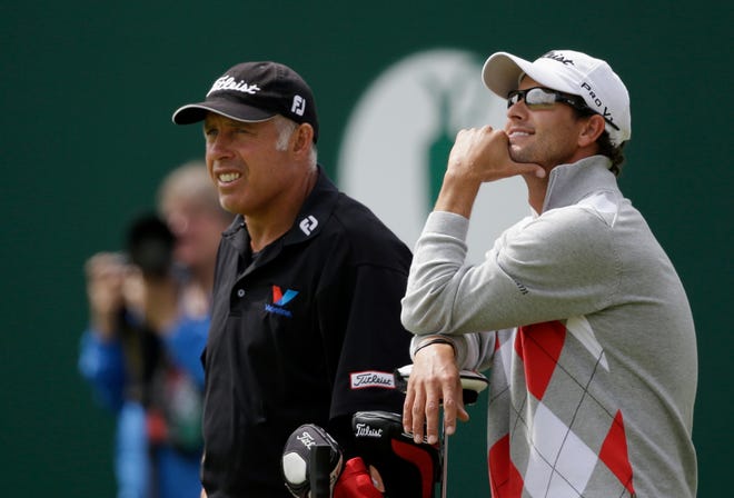 Adam Scott of Australia waits to putt on the 18th with caddie Steve Williams at Royal Lytham & St Annes golf club during the first round of the British Open Championship, Lytham St Annes, England, Thursday, July 19, 2012.