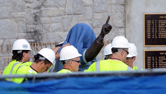 Penn State Office of Physical Plant workers cover the statue of former football coach Joe Paterno near Beaver Stadium on Penn State's campus in State College, Pa., on Sunday, July 22, 2012. The university announced earlier Sunday that it was taking down the monument in the wake of an investigative report that found the late coach and three other top Penn State administrators concealed sex abuse claims against retired assistant coach Jerry Sandusky. (AP Photo/Centre Daily Times, Christopher Weddle) MANDATORY CREDIT; MAGS OUT