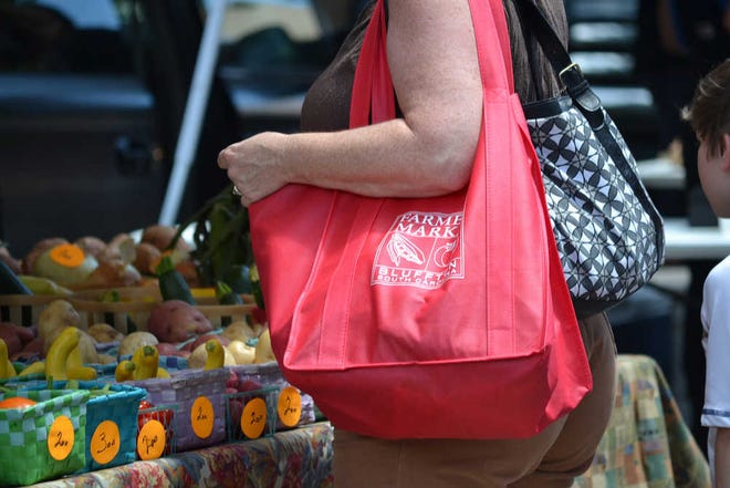 Jessica Sparks/ Bluffton Today Each participating family gets a red bag for the Bluffton Farmers Market to carry their food.