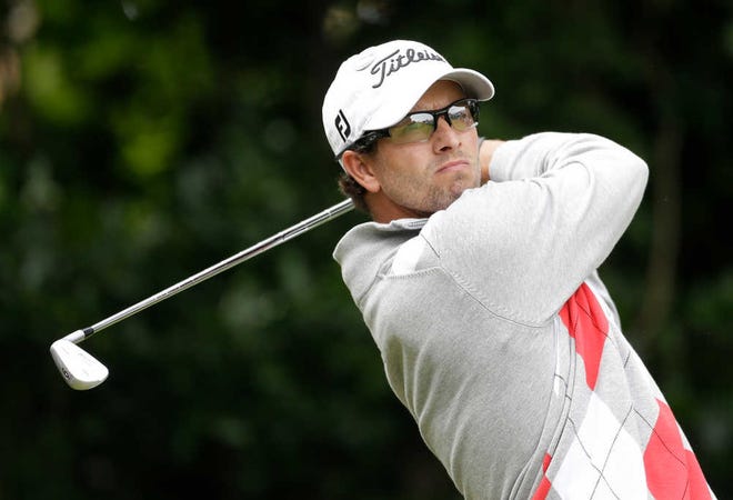Adam Scott plays a shot off the first tee Saturday during the third round of the British Open.