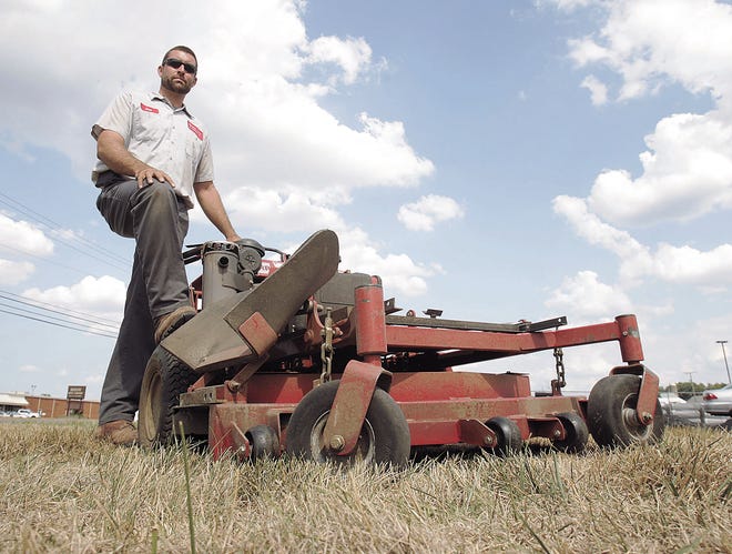 Ben Moretta, owner of Moretta Lawn and Landcare in Perry Township, stands in burned-out grass brought on by the drought.