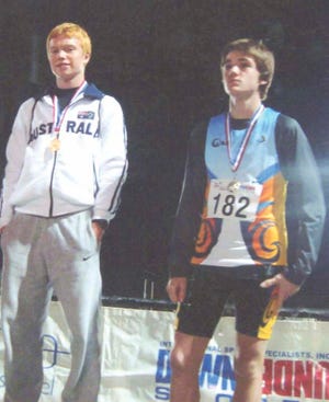 Michael Cook, left, stands atop the medal stand after winning a race in the Tri-Nations Meet in Australia.