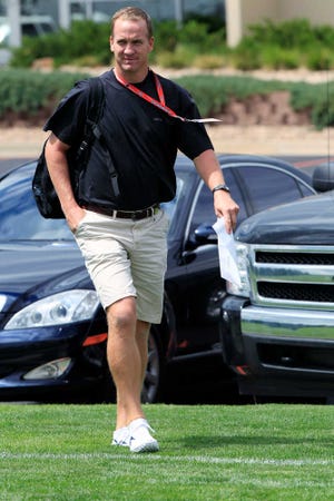 Denver Broncos quarterback Peyton Manning arrives for NFL football training camp on Wednesday, July 25, 2012, at the team's headquarters in Englewood, Colo. Practices begin on Thursday. (AP Photo/David Zalubowski)