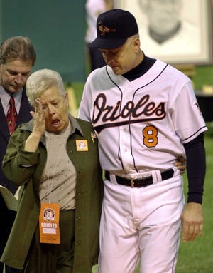 Cal Ripken, right, escorts his mother, Vi, from the field after throwing out the ceremonial first pitch before Cal Ripken's final game at Oriole Park in Baltimore in 2001. Police said Vi Ripken was abducted Tuesday and found unharmed Wednesday.