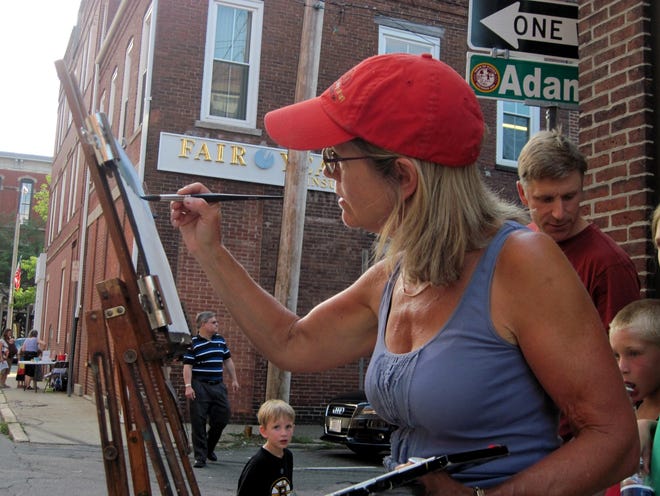 Watercolor artist Nancy Walton works on a landscape in front of Five Crows during the annual ArtWalk on July 19.