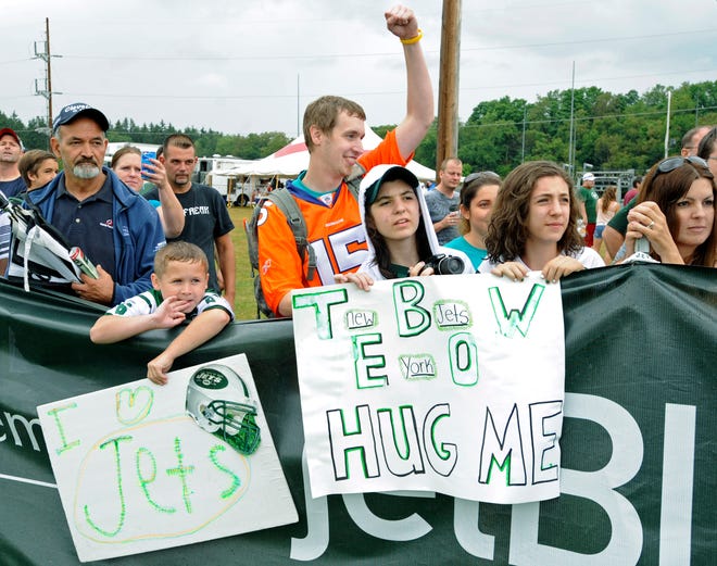 Fans watch the New York Jets at their NFL football training camp Saturday, July 28, 2012, in Cortland, N.Y. (AP Photo/Bill Kostroun)