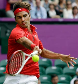Roger Federer of Switzerland celebrates his 6-3, 5-7, 6-3 victory over Alejandro Falla of Colombia at the All England Lawn Tennis Club in Wimbledon, London at the 2012 Summer Olympics,.