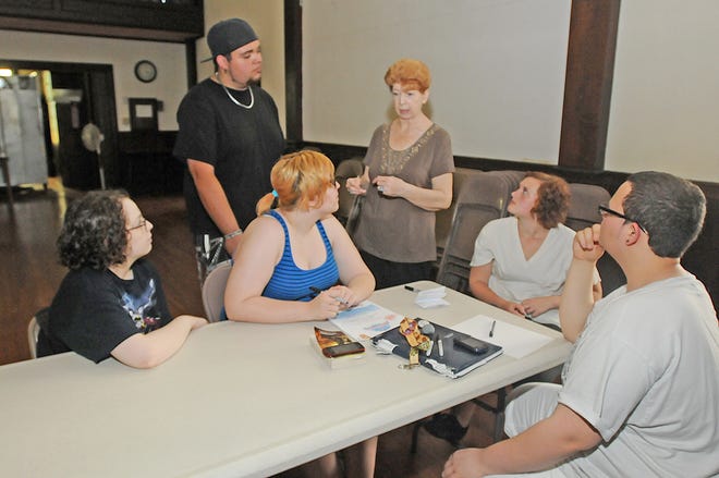 From left, Gabby and Morgan Ashley, Jonathan Reis, Silver City Teen Center director Annemarie Matulis, Taylor Lawrence and Alexander Cruz talk at the teen center’s new location at St. Thomas Church on High Street in Taunton.