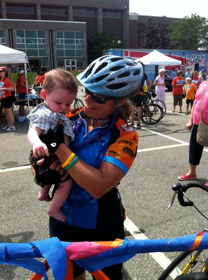 Pan-Mass rider Stephanie McAuley holds her son Mason McAuley.