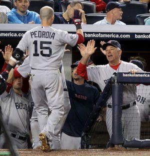 Boston Red Sox manager Bobby Valentine, right, greets Dustin Pedroia (15) after he hit a sacrifice fly during the ninth inning of a baseball game at Yankee Stadium in New York, Saturday, July 28, 2012. The Red Sox won 8-6. (AP Photo/Seth Wenig)