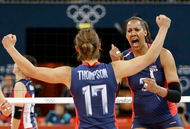 USA's Tayyiba Haneef-Park, right, celebrates with teammate Courtney Thompson after winning a set against South Korea during Saturday's women's volleyball preliminary match at the 2012 Summer Olympics in London.