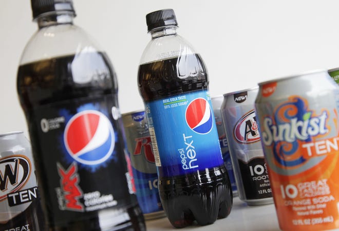 A June 11, 2012, photo shows bottles of Pepsi Next and Pepsi Max displayed amongst cans of ten-calorie sodas from PepsiCo. in New York. Coke and Pepsi are chasing after the sweet spot: a soda with no calories, no artificial sweeteners and no funny aftertaste. The world's top soft drink companies hope that's the elusive trifecta that will silence health concerns about soda and reverse the decline in consumption of carbonated drinks. But coming up with such a formula could still be years away.