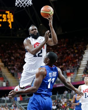 USA's James Harden goes to the basket against France's Florent Pietrus during the second half of a preliminary men's basketball game at the 2012 Summer Olympics, on Sunday, July 29, 2012, in London.