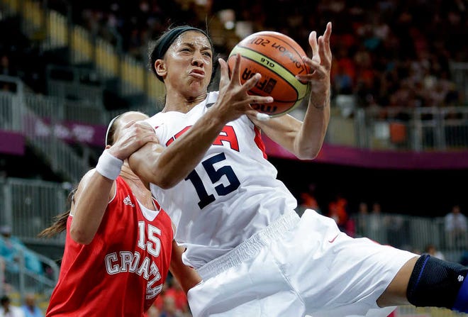 USA's Candace Parker, right, is grabed from behind by Croatia's Jelena Ivezic, left, during the second half of a preliminary women's basketball game at the 2012 Summer Olympics, Saturday, July 28, 2012, in London. (AP Photo/Eric Gay)