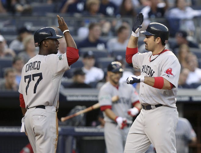 Boston Red Sox's Adrian Gonzalez, right, is greeted by Pedro Ciriaco after hitting a three-run home run during the fifth inning of the baseball game against the New York Yankees at Yankee Stadium in New York, Saturday, July 28, 2012. ()