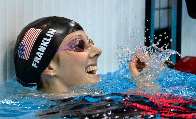 United States' Missy Franklin reacts after winning gold in the women's 100-meter backstroke swimming final Monday at the Aquatics Centre during the Olympics.