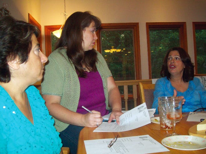 Debbie Ryan, Gwen McNamara and Yolanda Goldsack discuss agenda ideas at a meeting of Pike County United Women.