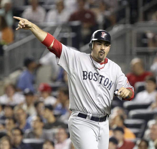 The Red Sox's Adrian Gonzalez reacts after scoring on a double by Ryan Sweeney on Sunday during the second inning against the Yankees at Yankee Stadium in New York.