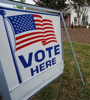 A voter departs a the polls, Tuesday, July 31, 2012, in Kennesaw, Ga. Georgia voters heading to the polls will settle primary races in congressional districts across the state. (AP Photo/Mike Stewart)