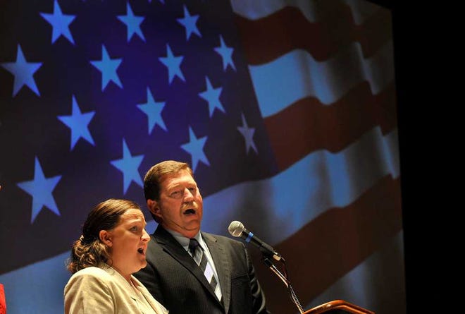 MICHAEL SCHUMACHER / AMARILLO GLOBE-NEWS Teachers Lynita Foster and Buddy Wallace sing the national anthem Tuesday to open the Vocational Agriculture Teachers Association of Texas conference, which is being held this week at Amarillo Civic Center. Also singing the anthem was Chandra Corse, not pictured.
