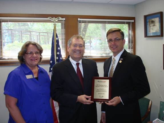 At right, Cong. Bobby Schilling (R-17th) receives the RetireSafe “Standing Up For America’s Seniors” Award commemorative plaque recognizing his accomplishments and service to older Americans. The presentation was made Friday at Schilling’s district office in Moline by Thair Phillips (center), president of RetireSafe, and Mary Bivens with the In-Touch Adult Day Center
