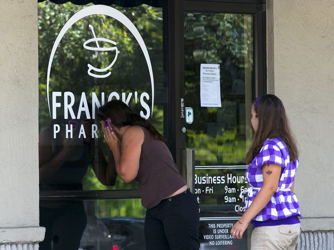 After checking the door, customers Margarita Bruno and her daughter Latisha Fullard look inside after Franck's Pharmacy closed on Southwest 17th Street on Tuesday. A note on the door said prescriptions had been moved to other pharmacies.