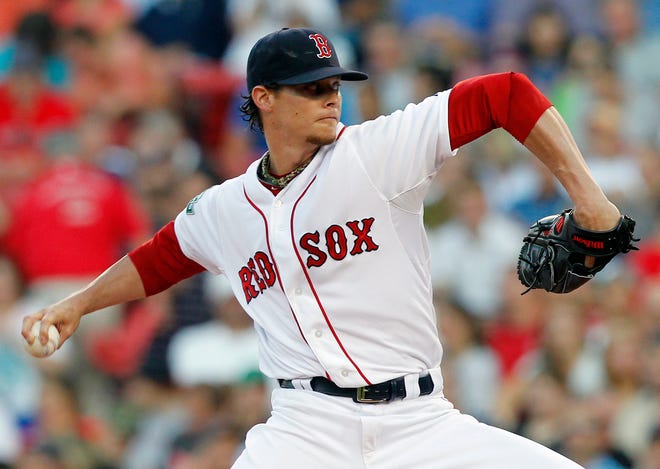 Boston Red Sox pitcher Clay Buchholz throws in the first inning of a baseball game against the Detroit Tigers in Boston, Monday, July 30, 2012.