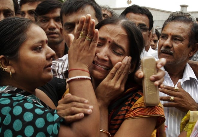 Relatives of Hindus sentenced to life imprisonment for the deaths of Muslims in sectarian violence 10 years ago weep after the verdict in Mehsana, Gujarat state, India, this week.