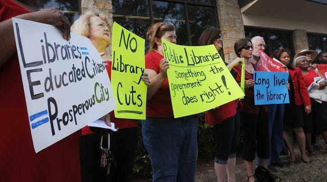 The Times-Union Protestors rallied against cuts to the Jacksonville public libraries last September. Supporters hope a plan to levy a one-mill property tax would raise money to do away with reduced hours and cuts at the libraries.