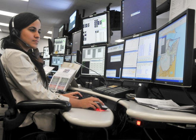 Doraliz Rodriguez works at her multi-screen dispatch station in the Navy Region Southeast Regional Dispatch Center.