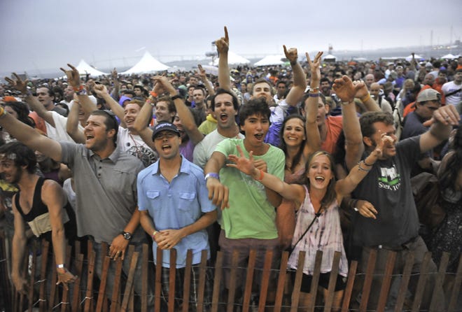 My Morning Jacket fans cheer as a storm rolls in at the Newport Folk Festival.