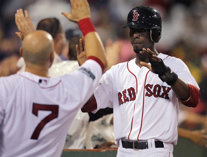 Boston Red Sox's Pedro Ciriaco is welcomed to the dugout after scoring on an error by Detroit Tigers second baseman Omar Infante in the fourth inning of a baseball game at Fenway Park, in Boston on Tuesday, July 31, 2012. ()