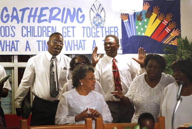 The choir sings praise songs during “The Gathering: When All God's Children Get Together,” a Missionary Society program Sunday afternoon at Mount Olive AME Church in east Gainesville.