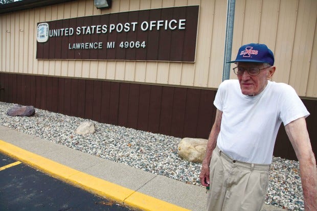 Jim Husa, 87, stands outside a U.S. Post Office in Lawrence, Mich. The U.S. Postal Service is bracing for a first-ever default on billions in payments due to the Treasury. (AP PHOTO/ROBERT RAY)