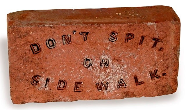 This handmade brick reminds sidewalk strollers to mind their manners.