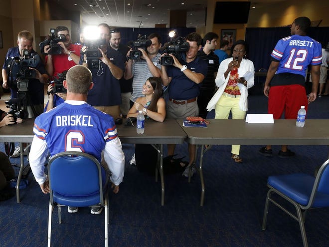 Florida quarterback Jeff Driskel fields questions from various media during UF Football Media Day at the Ben Hill Griffin Stadium Touchdown Terrace on the UF campus Thursday. Florida quarterback Jacoby Brissett is seen on the right.