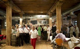 Visitors attend the opening of the German House at Museum of London Docklands for the 2012 London Summer Olympics.
